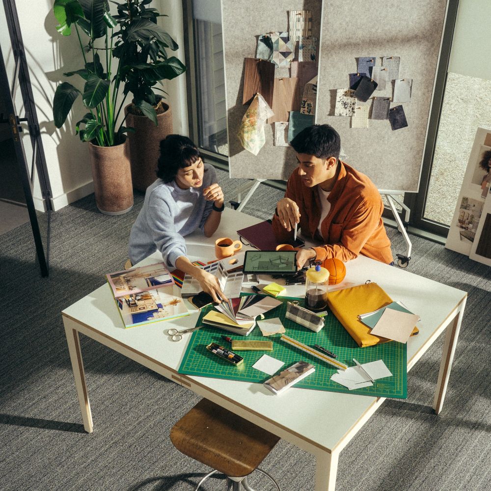 Interface WW860 plank carpet tile in work studio with man and woman collaborating